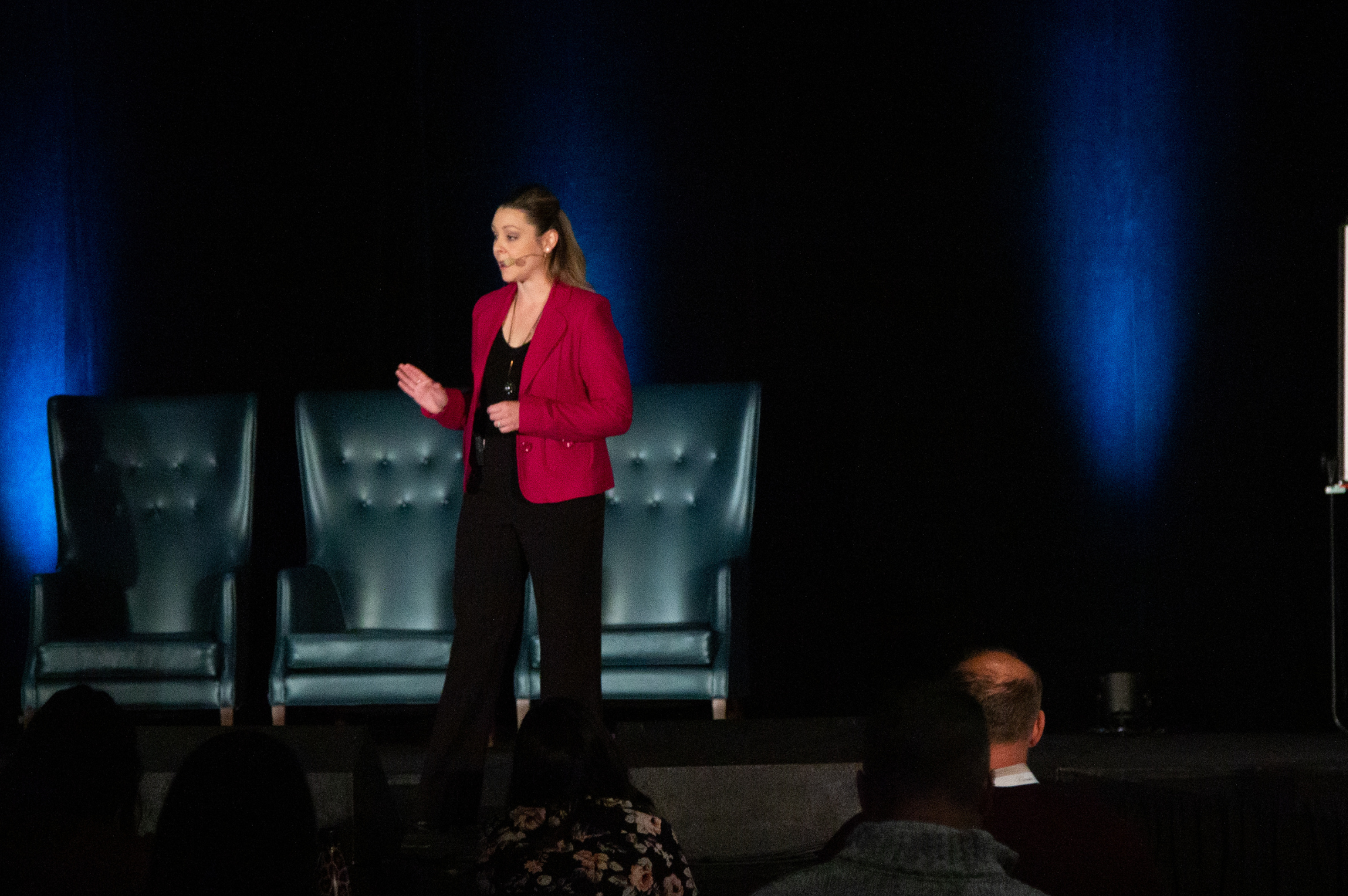 Kady on Stage Ultimate Team Summit Kady on Stage in a bright Fuchsia blazer and black pants speaking at The Ultimate Team Summit in Niagara